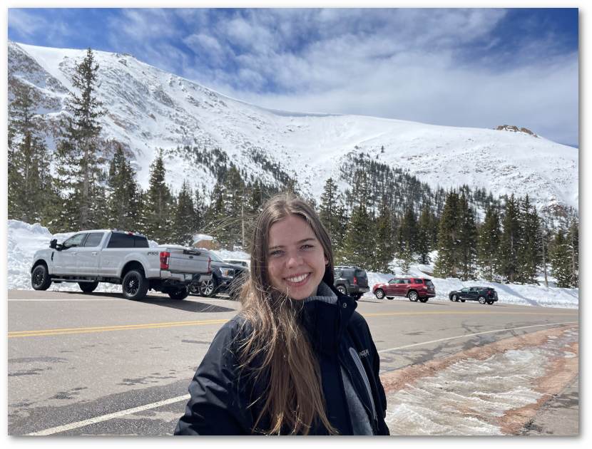 Kellie Smith in front of snow-capped mountains